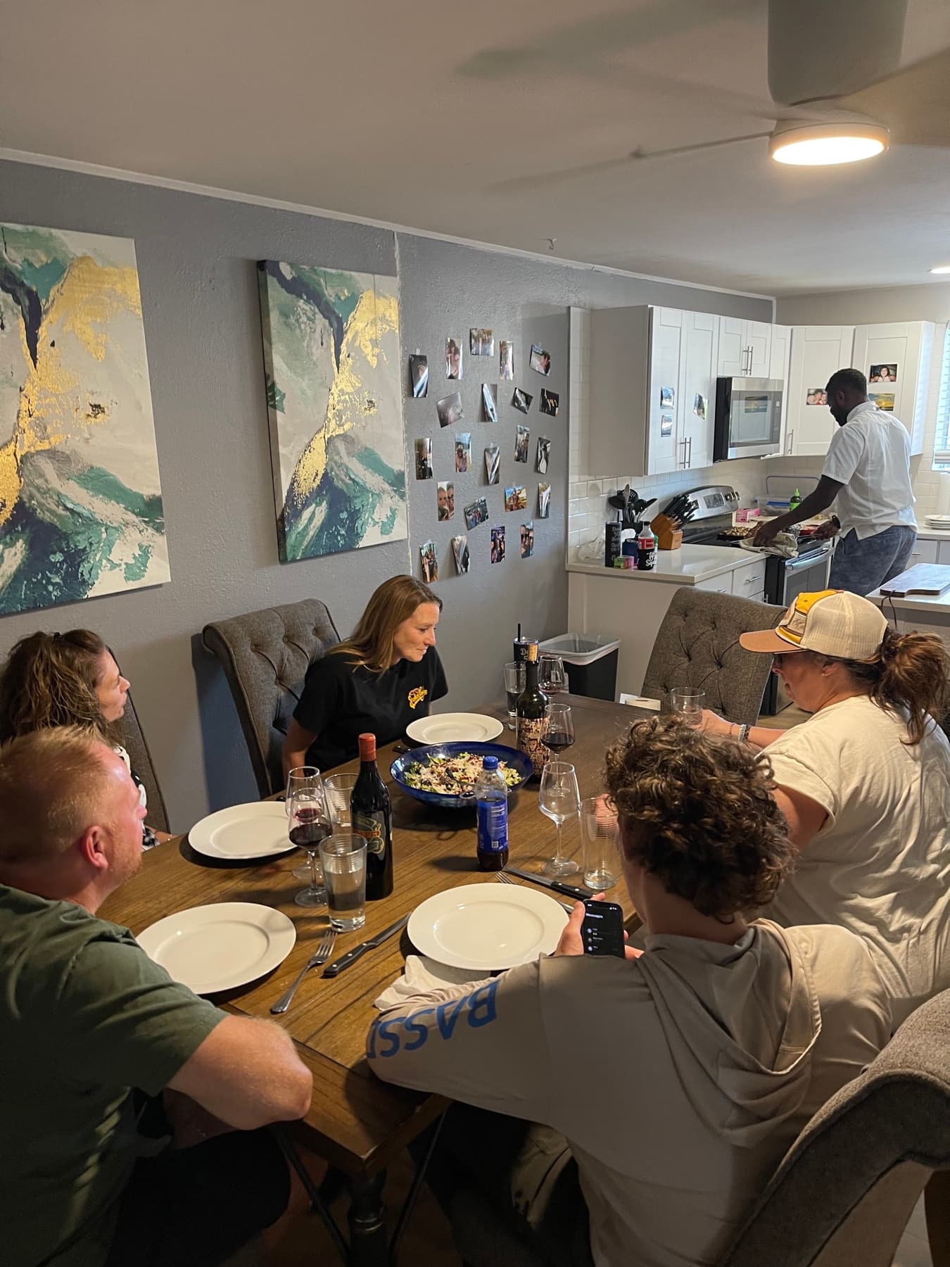 A group sharing a chef-cooked dinner around the table in an Arvada vacation rental