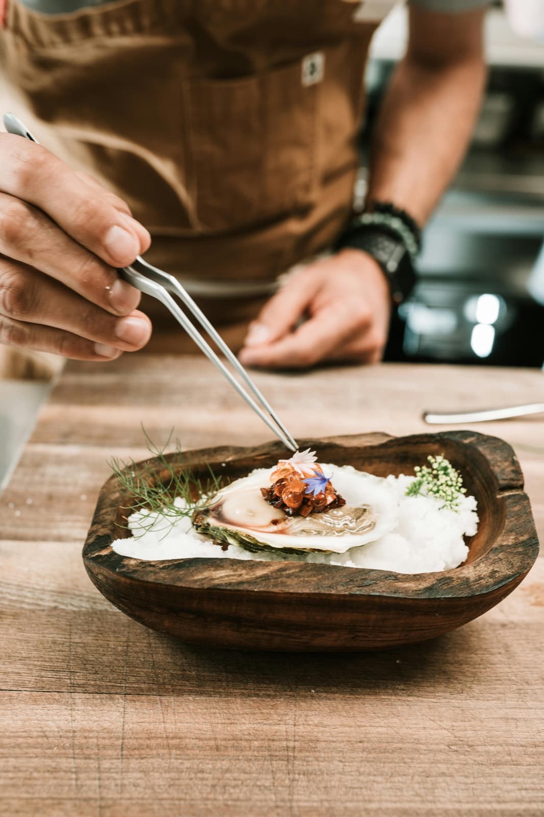 A chef plating a fine-dining course by hand