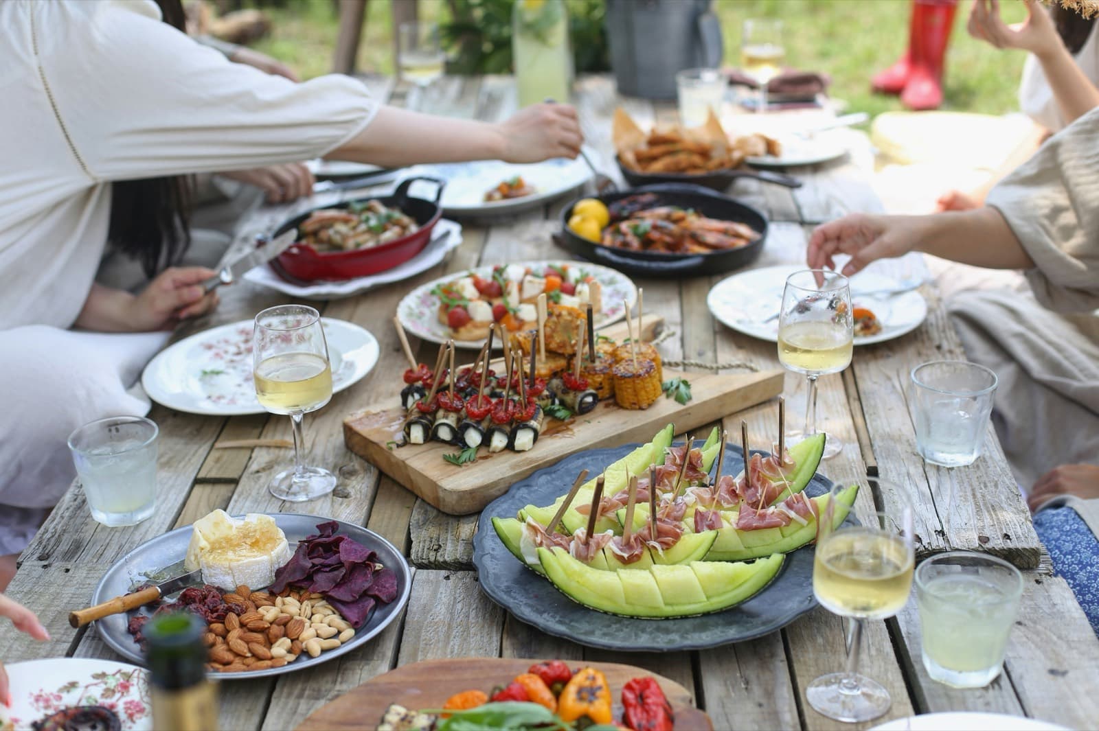 An outdoor table where several families are eating together